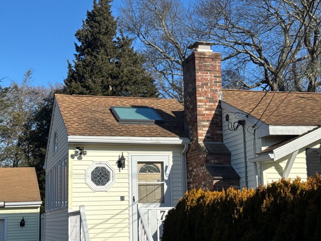 VELUX fixed skylight with solar-powered blinds on resawn shake roof in Jamestown RI by Pinnacle Roofing
